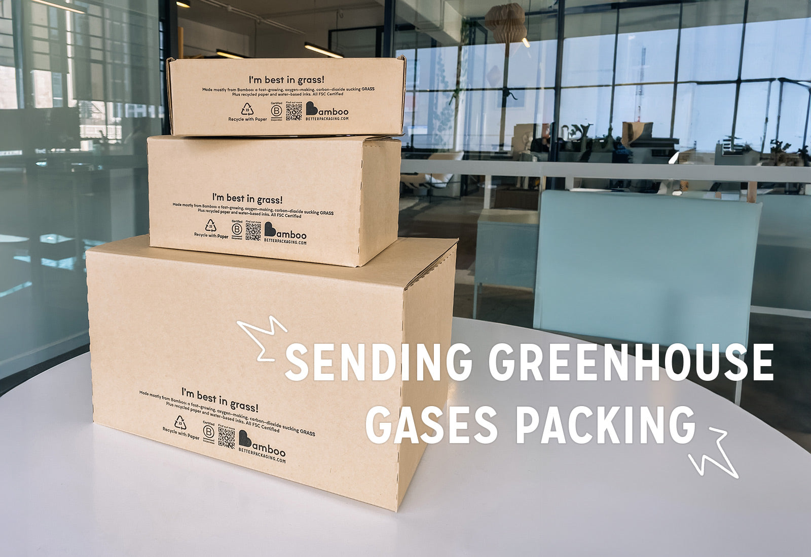 Stacked pile of bamboo boxes with a message "sending greenhouse gases packing" advocating eco-friendly packaging.